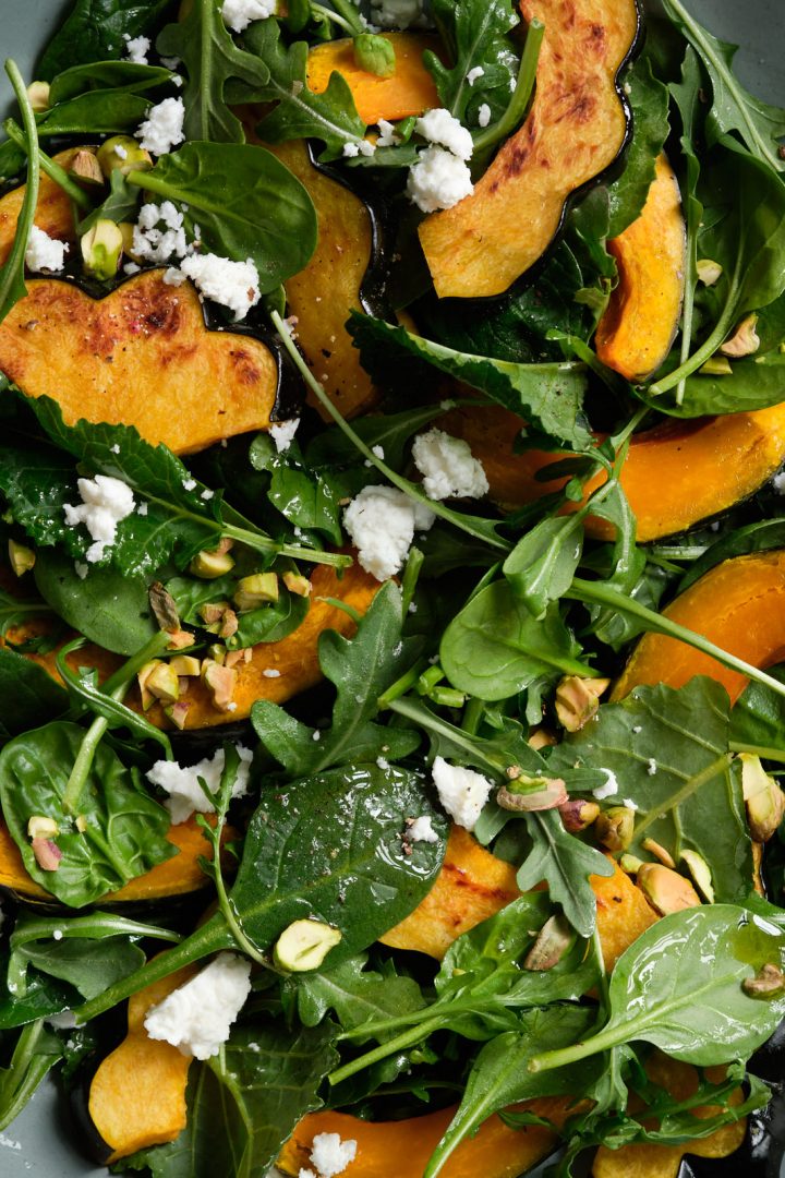 Roasted winter squash salad with greens, pistachios and feta cheese